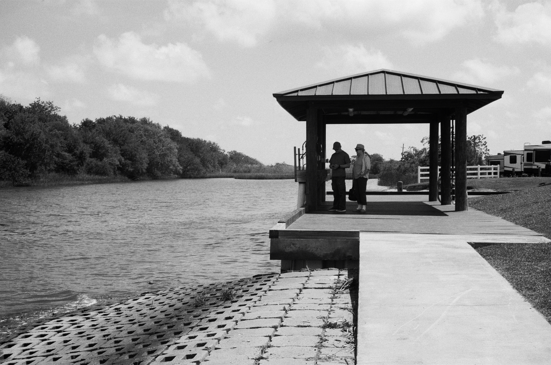 Covered dock beside a quiet canal