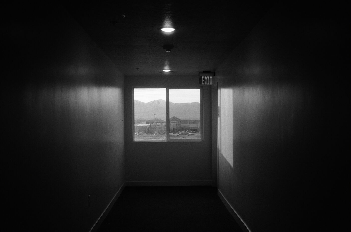 Dark hallway with a window looking out to mountains